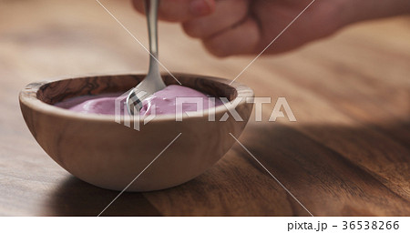young female hand eating blueberry yogurt with young female hand eating blueberry yogurt with 36538266