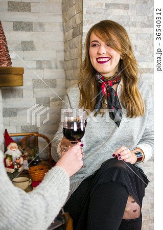Friends toasting with wine at house party Friends toasting with wine at house party 36540312