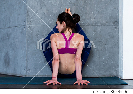 Back view of muscular young woman doing advanced Back view of muscular young woman doing advanced 36546469
