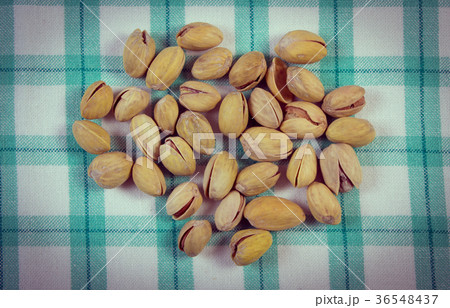 Pistachio nuts on checkered tablecloth 36548437