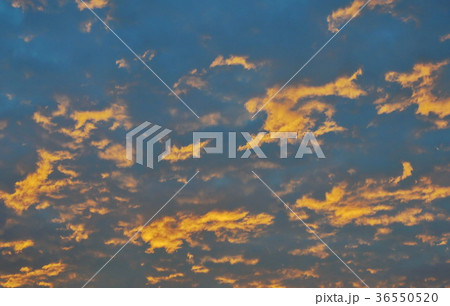 orange cloud spreading on sky in morning 36550520