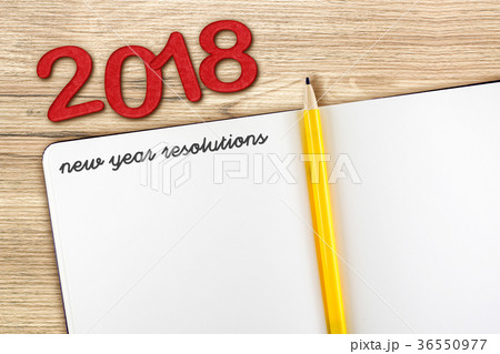 Top view of 2018 new year resolution with notebook 36550977