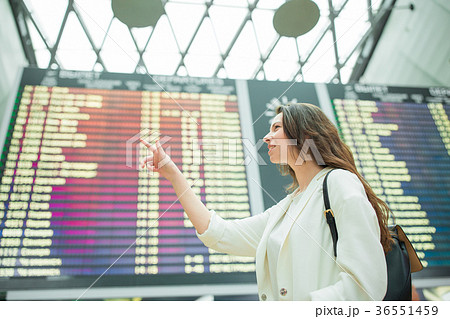 Young woman in international airport looking at Young woman in international airport looking at 36551459