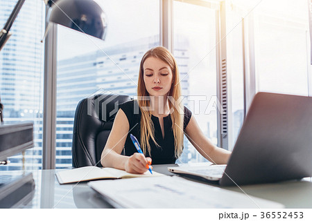 Female chief executive sitting at her desk taking 36552453