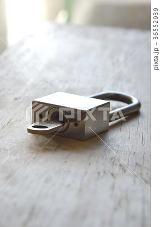 padlock unlocked on wooden board 36552939