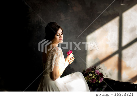 Bride in white dress sitting on chair Bride in white dress sitting on chair 36553821