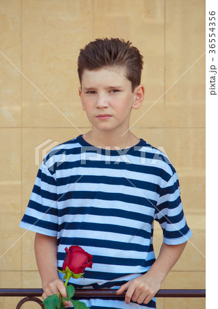 boy holding a rose and smiling. the concept of 36554356