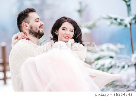 young couple on a walk in the snowy mountains 36554543