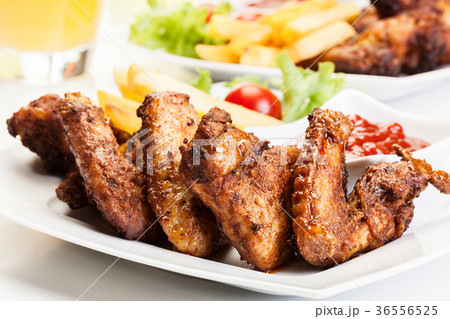 Chicken wings with fries french and spicy sauce Chicken wings with fries french and spicy sauce 36556525