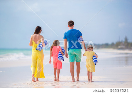 Back view of a young family on tropical beach Back view of a young family on tropical beach 36557522