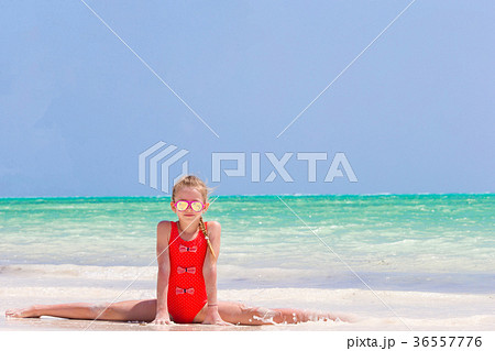 Active little girl on white beach having fun 36557776