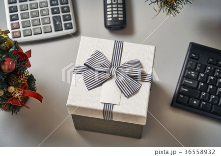Christmas tree and a gift box on the working place Christmas tree and a gift box on the working place 36558932