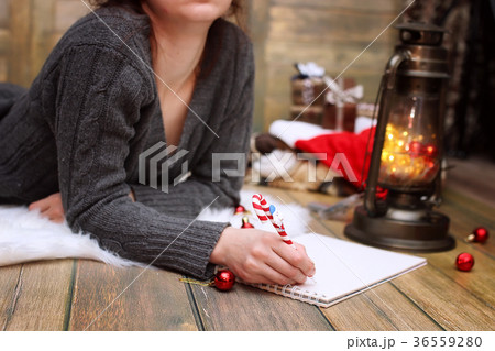 girl writes pen on a piece of paper Christmas girl writes pen on a piece of paper Christmas 36559280