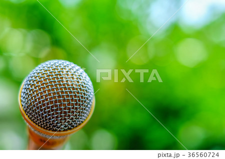 Microphone on natural blurred green background 36560724