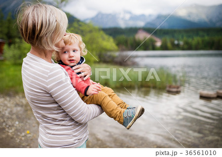 Senior woman with little boy at the lake, summer Senior woman with little boy at the lake, summer 36561010