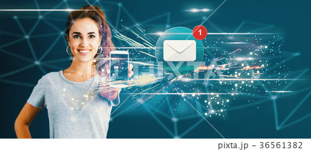 Email with young woman holding out a smartphone  36561382