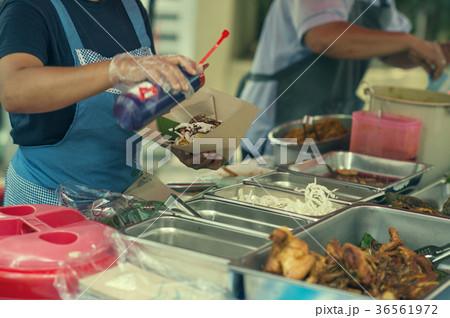 A woman selling a traditional local food Pecal  36561972