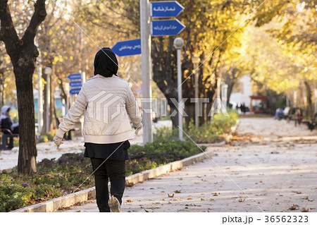 Backside of a Muslim woman walking in a park 36562323