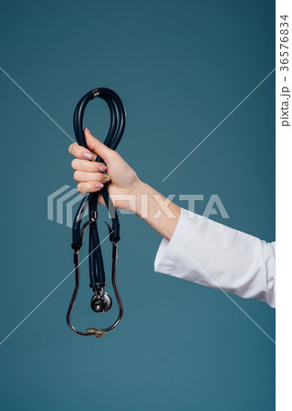female doctor's hand holds a stethoscope female doctor's hand holds a stethoscope 36576834