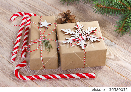 Christmas gift boxes and fir tree branch on wooden Christmas gift boxes and fir tree branch on wooden 36580055