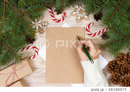 Female hands writing a letter to Santa Claus. 36580075