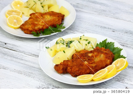 Wiener schnitzel and boiled potatoes Wiener schnitzel and boiled potatoes 36580419
