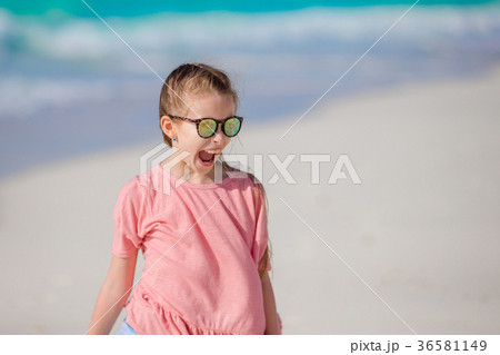 Portrait of adorable little girl at beach during Portrait of adorable little girl at beach during 36581149
