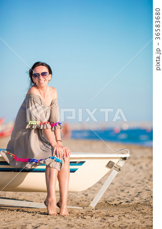 Young beautiful woman on beach during summer Young beautiful woman on beach during summer 36583680
