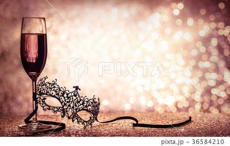 carnival mask and glass with glittering background 36584210