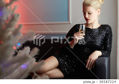 beautiful young woman drinking champagne at home 36587224
