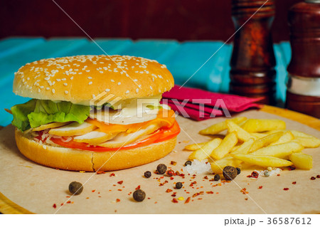 burger with meat cutlet, on turquoise table. 36587612