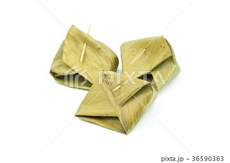 Thai dessert wrapped in banana leaf isolated Thai dessert wrapped in banana leaf isolated 36590363