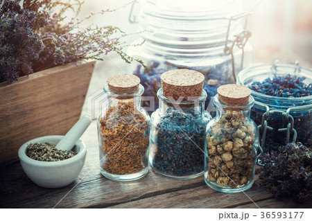 Bottles and jars of healing herbs 36593177