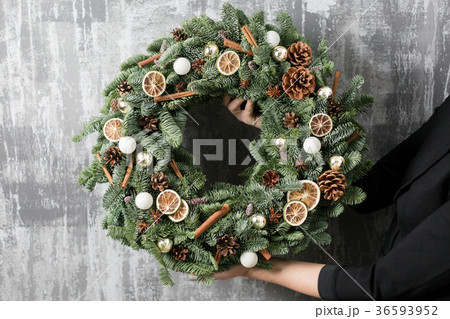 Beautiful Christmas wreath in woman hands Beautiful Christmas wreath in woman hands 36593952
