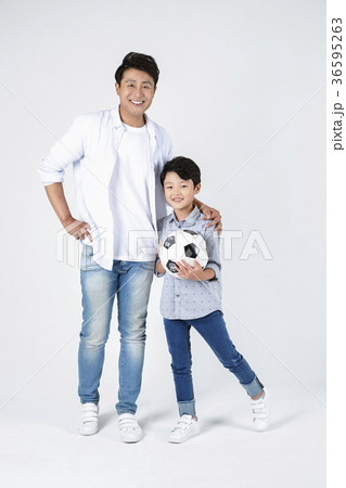 Young father and son playing with a ball and riding  a bicycle together portrait. Studio shot. 047 36595263