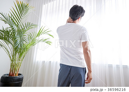 Young guy standing at the front of window with bright sunlight. 168 36596216