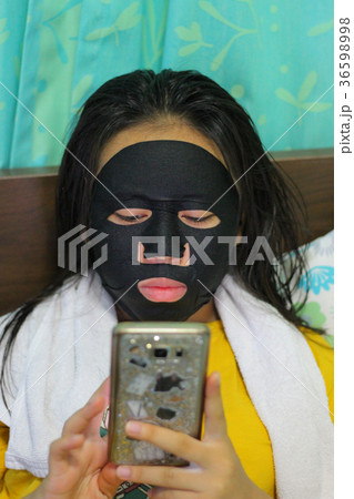 Young beautiful woman is having a black mask  36598998