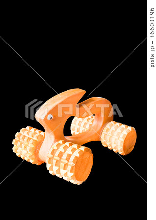 Wooden massage tool isolated on black background. Wooden massage tool isolated on black background. 36600196