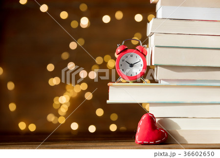 Vintage alarm clock and pile of books  36602650