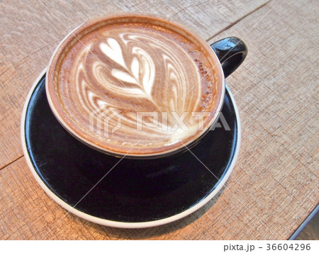 Cup of coffee on the wooden table with latte art. Cup of coffee on the wooden table with latte art. 36604296