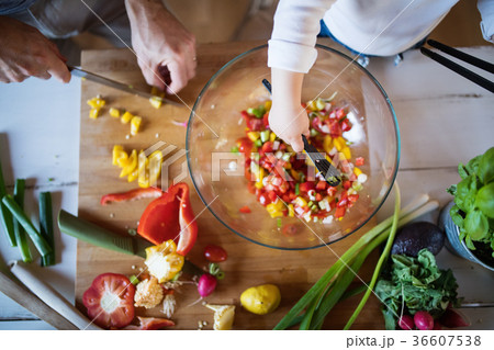Young father with a toddler boy cooking. 36607538