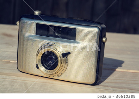 Old vintage golden Penti I camera on wood Old vintage golden Penti I camera on wood 36610289