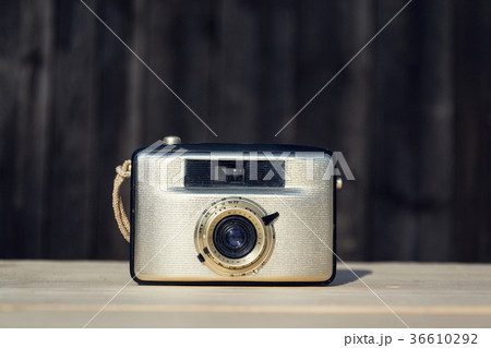 Old vintage golden Penti I camera on wood Old vintage golden Penti I camera on wood 36610292