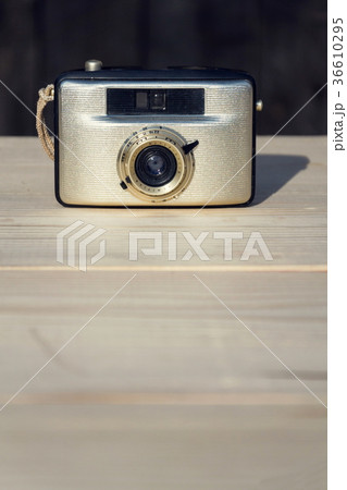 Old vintage golden Penti I camera on wood Old vintage golden Penti I camera on wood 36610295