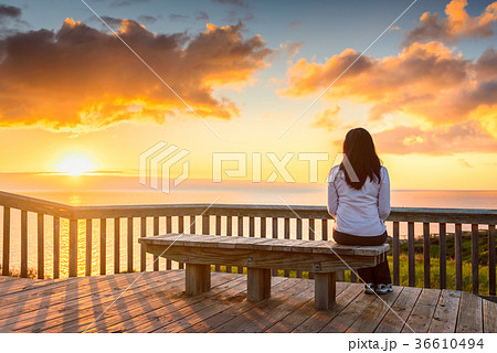 Woman looking at sunset at Hallett Cove boardwalk 36610494