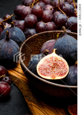 Ripe Grapes and Figs on dark concrete background 36611669
