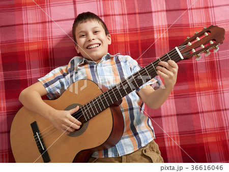 boy playing music on guitar boy playing music on guitar 36616046