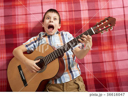 boy playing music on guitar boy playing music on guitar 36616047