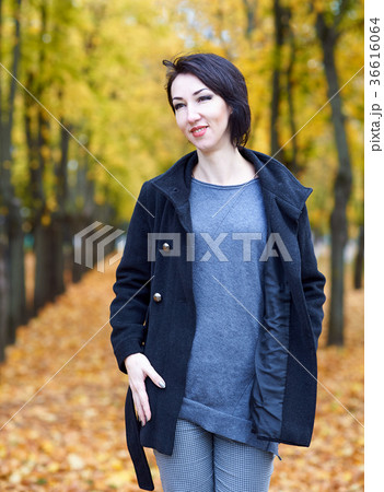 woman posing in autumn park with yellow trees 36616064