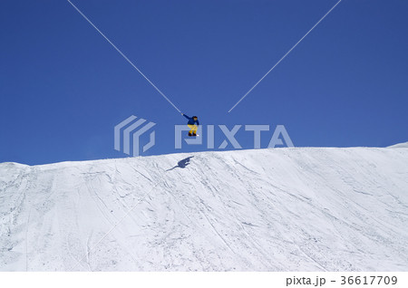 Snowboarder jumping in terrain park on winter day Snowboarder jumping in terrain park on winter day 36617709